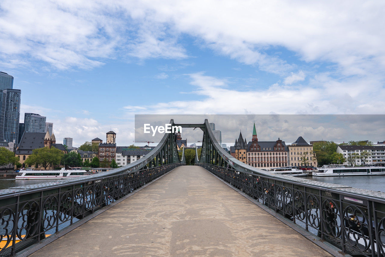 view of bridge over river in city against sky