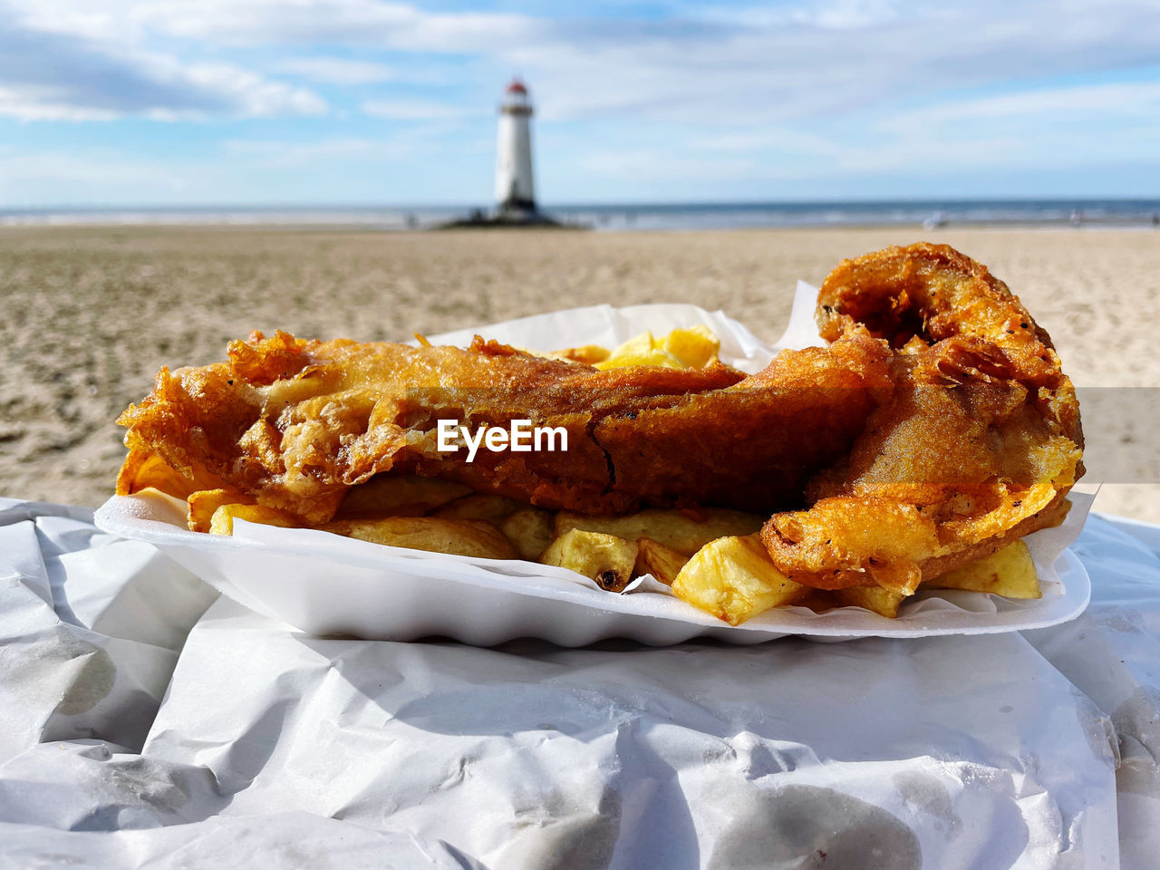 food, fast food, food and drink, land, sea, beach, water, nature, sky, dish, no people, lighthouse, snack, fried food, cloud, meal, focus on foreground, day, sand, outdoors