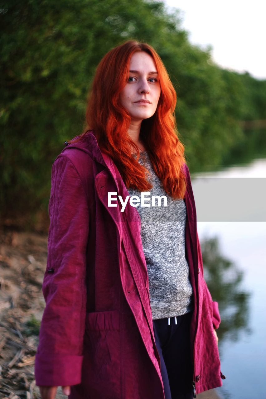 Portrait of young woman standing outdoors