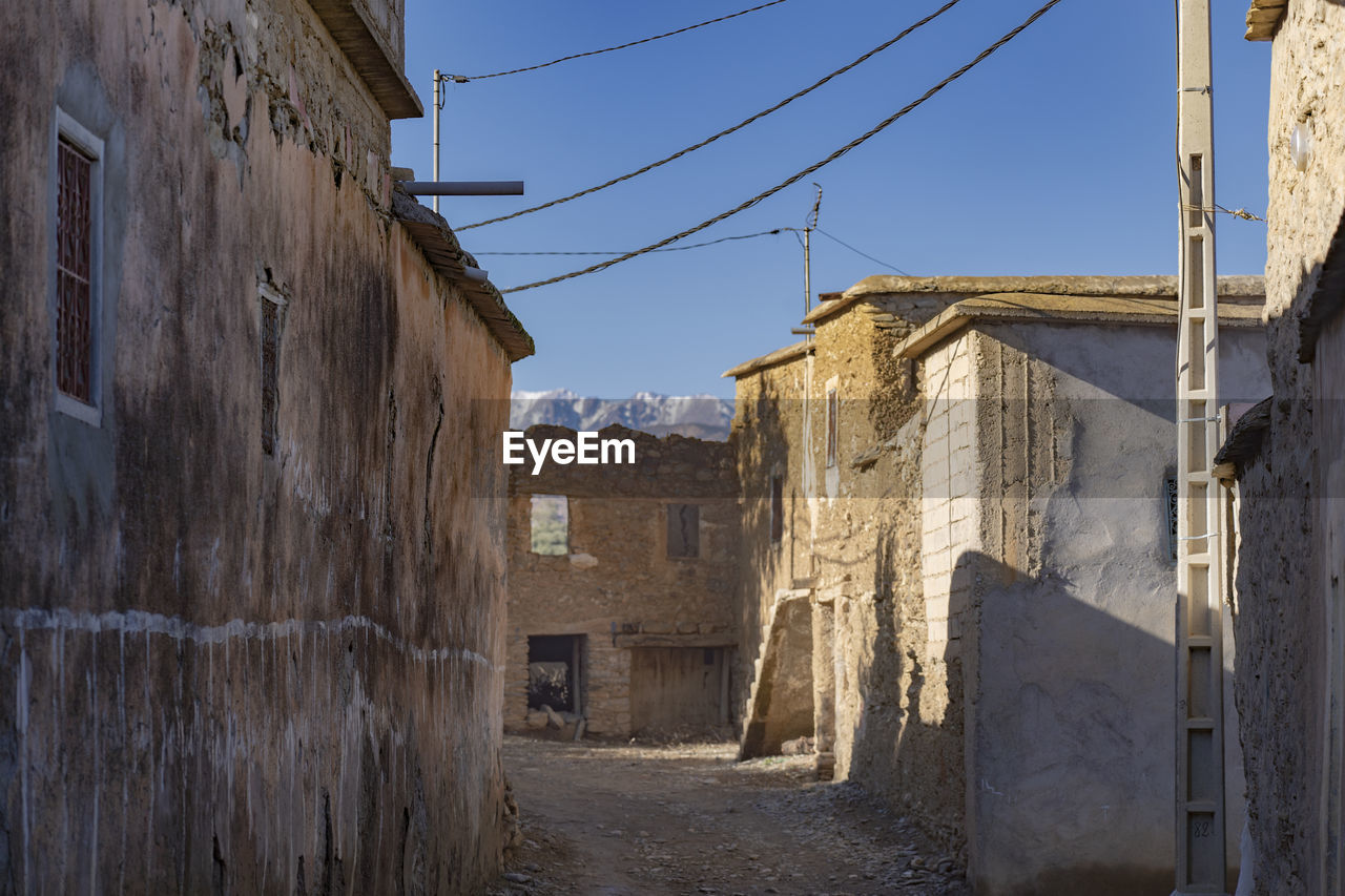 Alley amidst buildings in city against sky