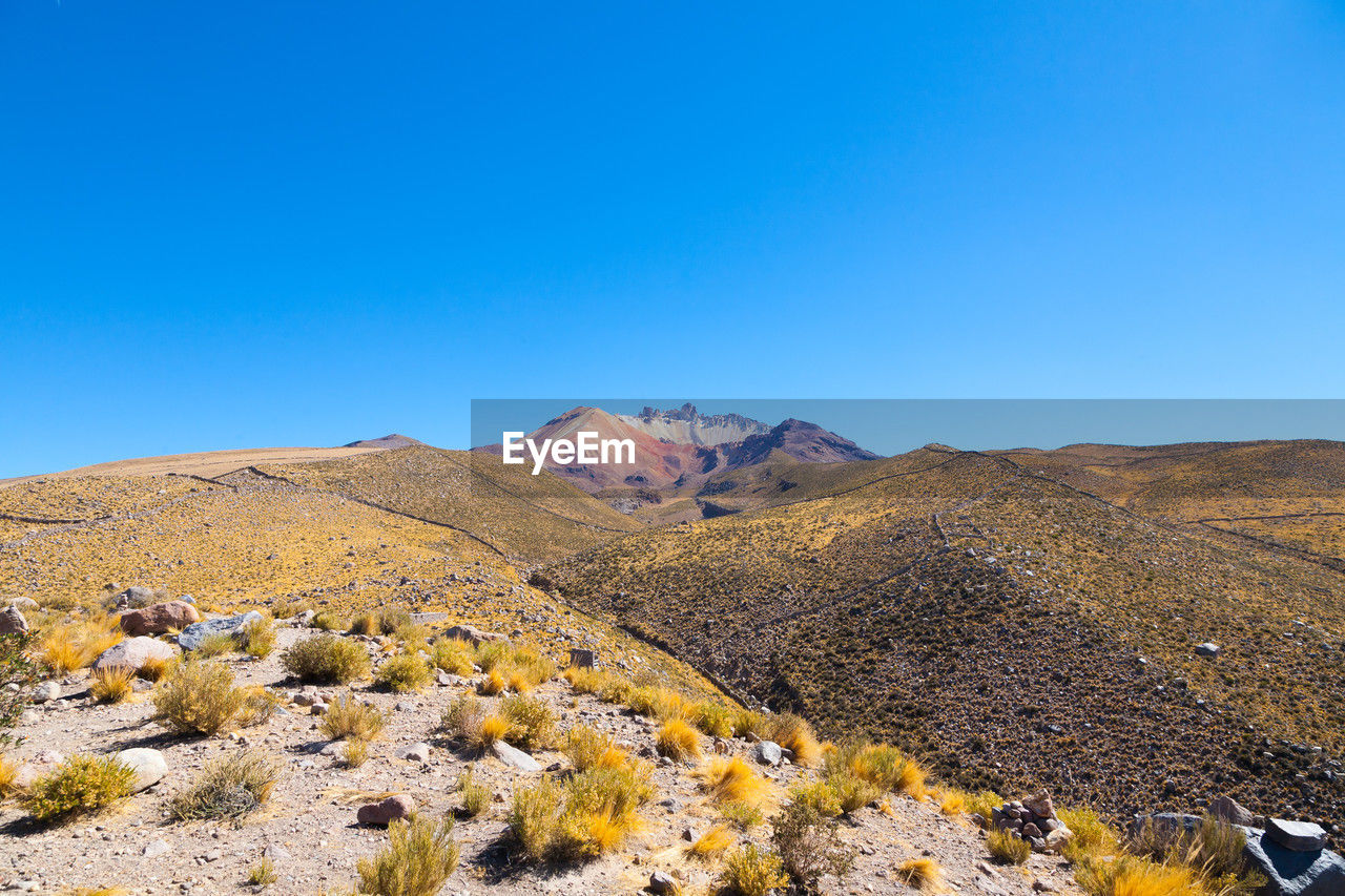 scenic view of mountains against clear blue sky