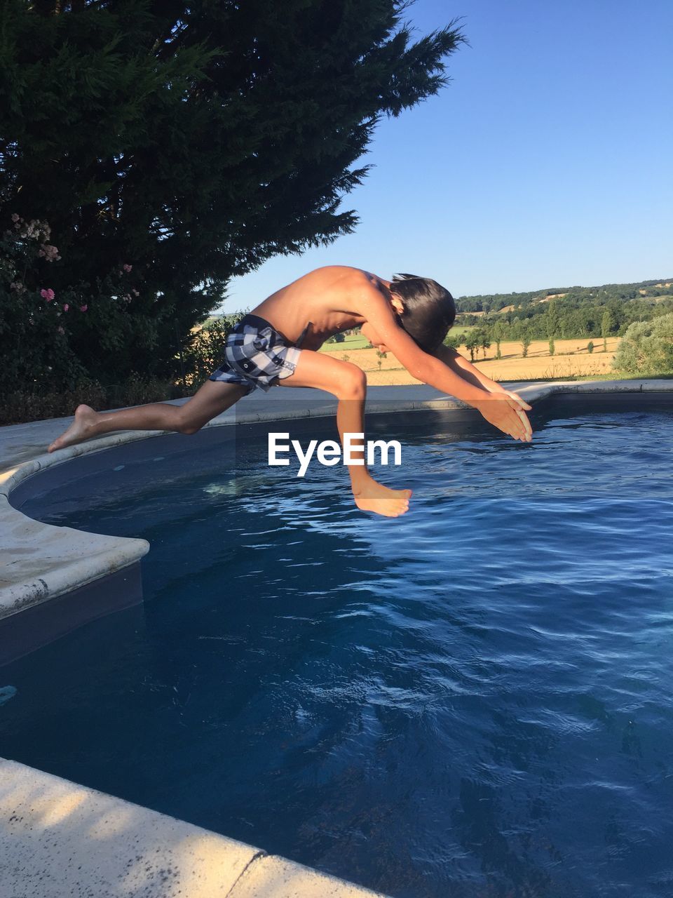 Boy jumping in swimming pool