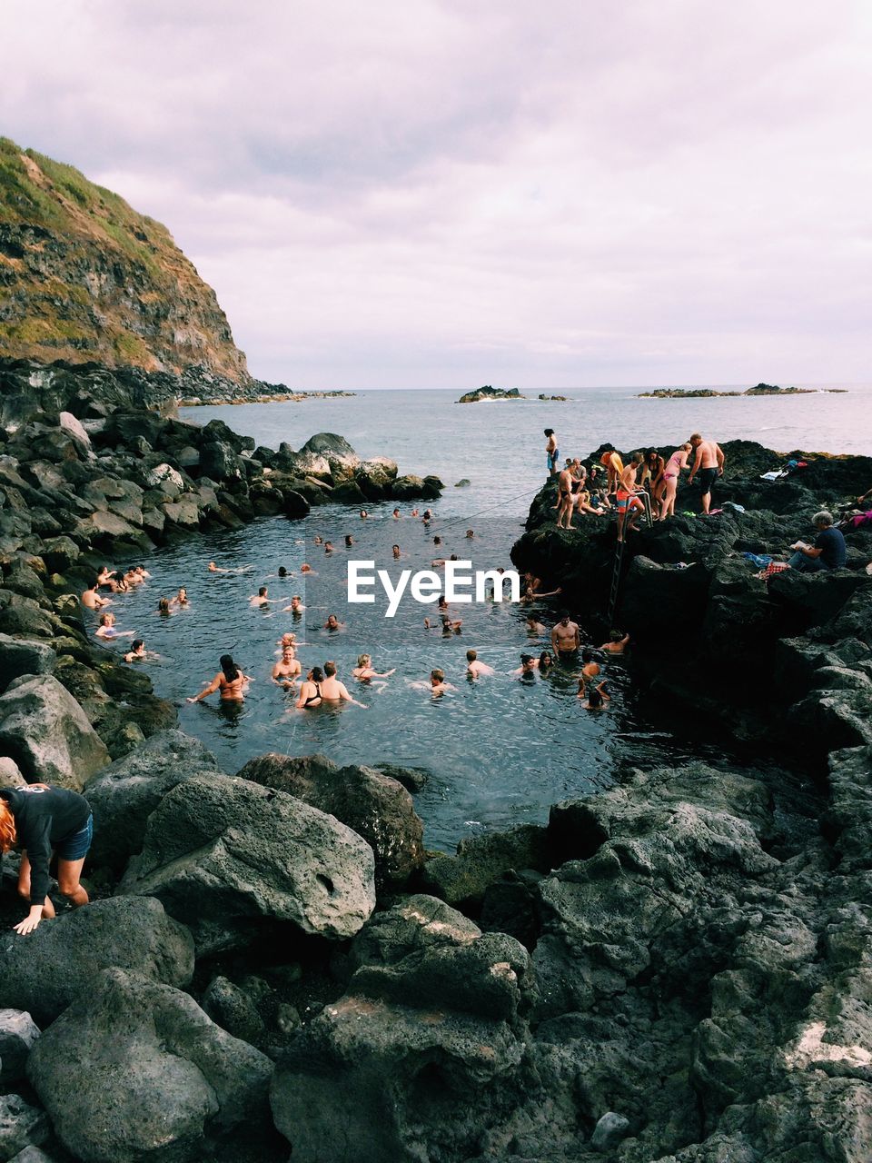 People on stony beach