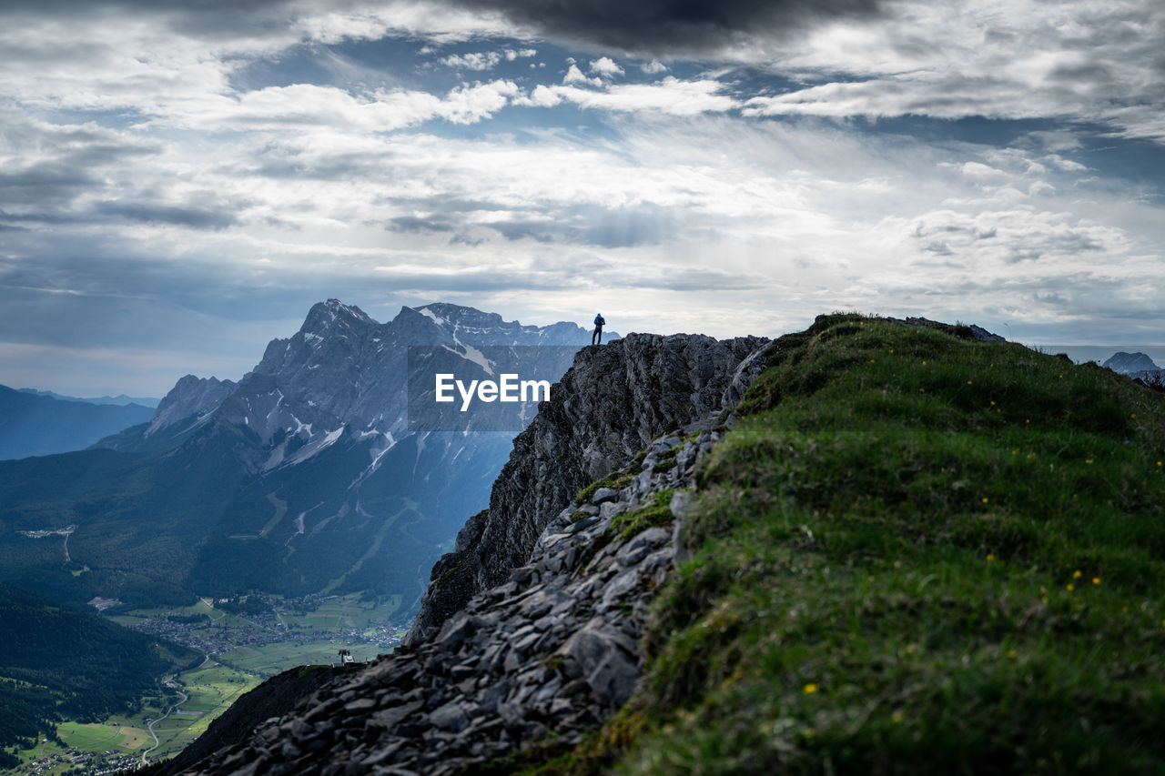 Scenic view of mountains against cloudy sky