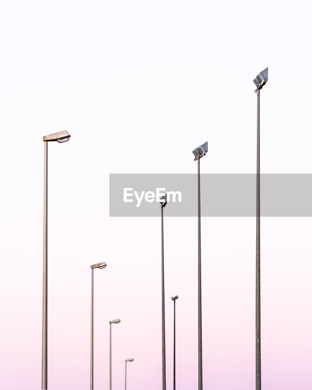 Low angle view of street lights against clear sky during sunset