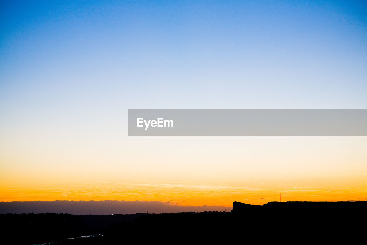 Scenic view of landscape at sunset