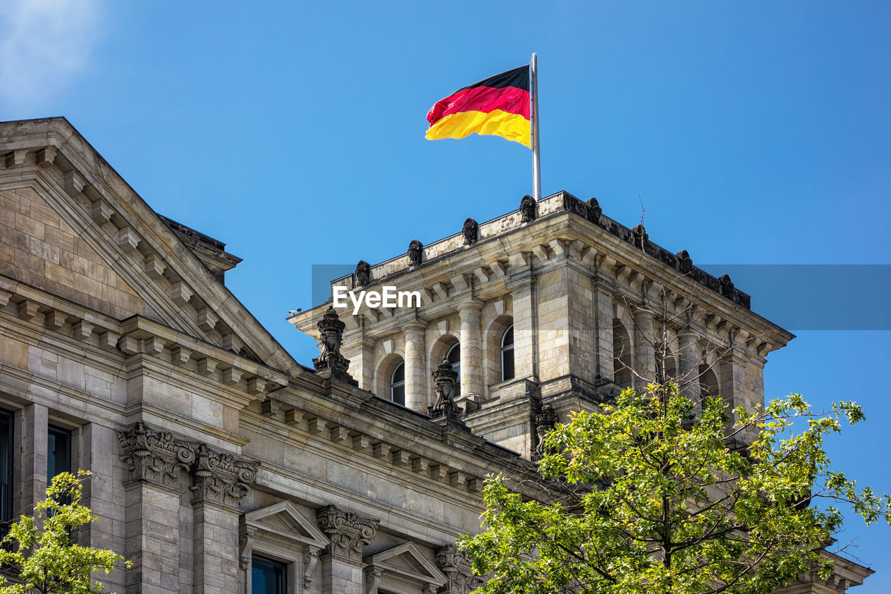 Low angle view of flag against building