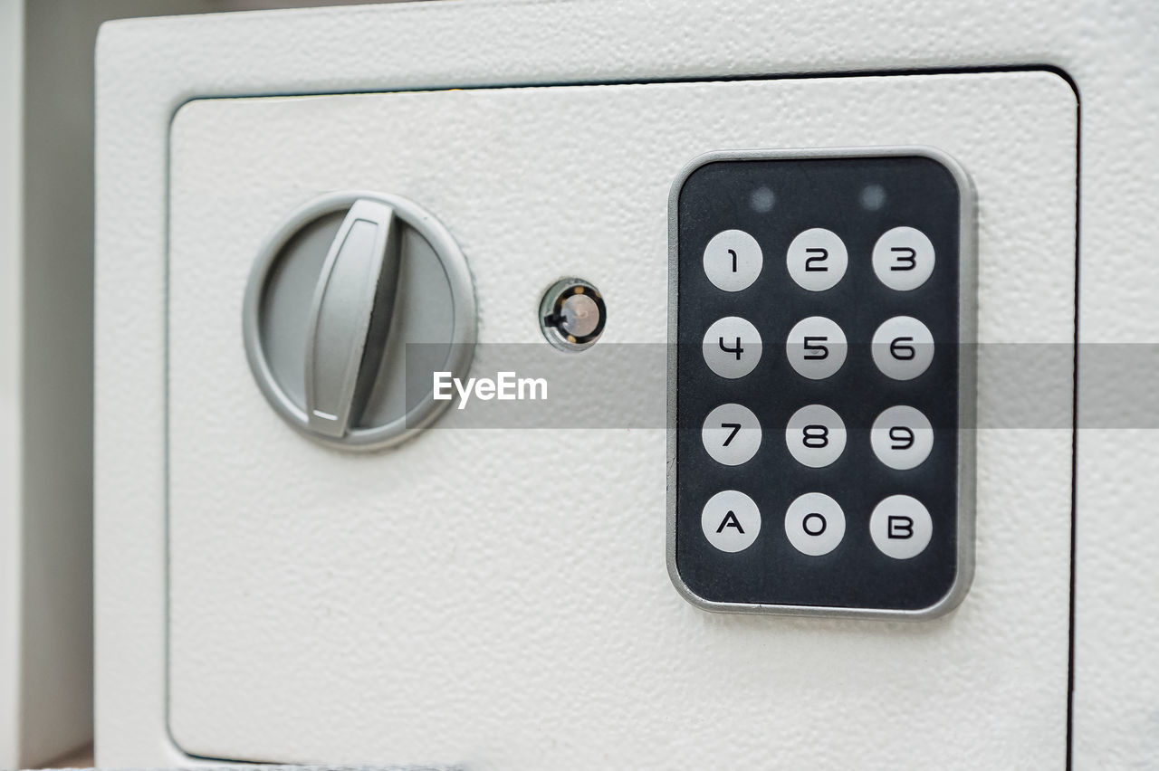 White compact safe with key and combination lock. deposit module for storing money and documents