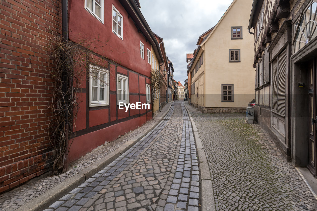 FOOTPATH AMIDST RESIDENTIAL BUILDINGS