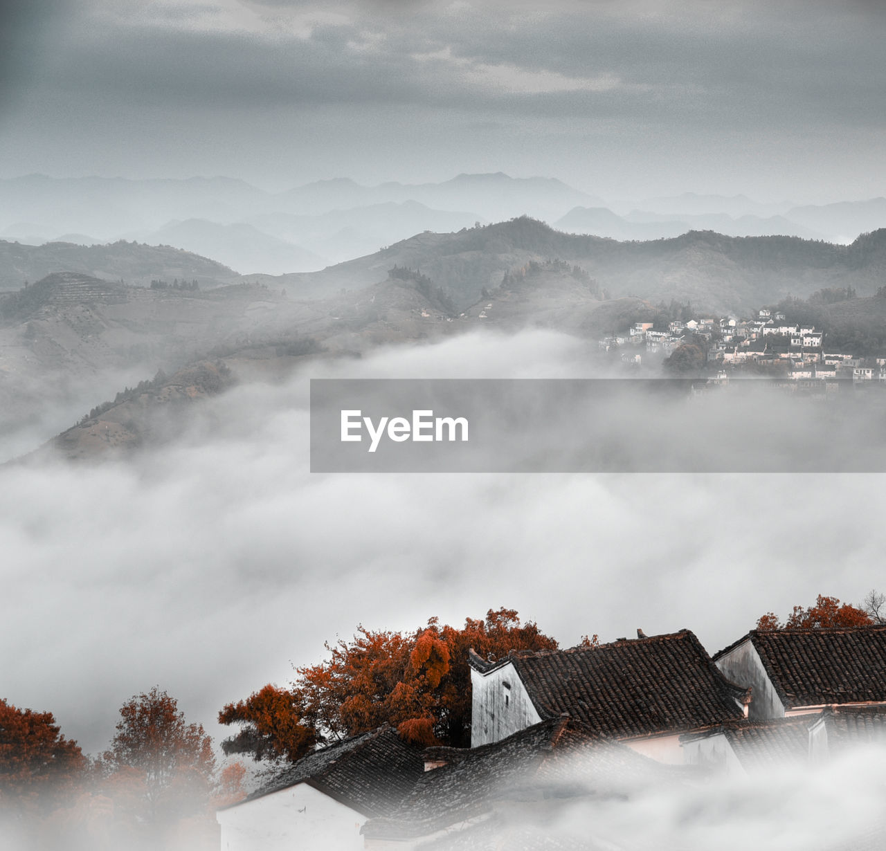 Houses by mountains against sky during winter