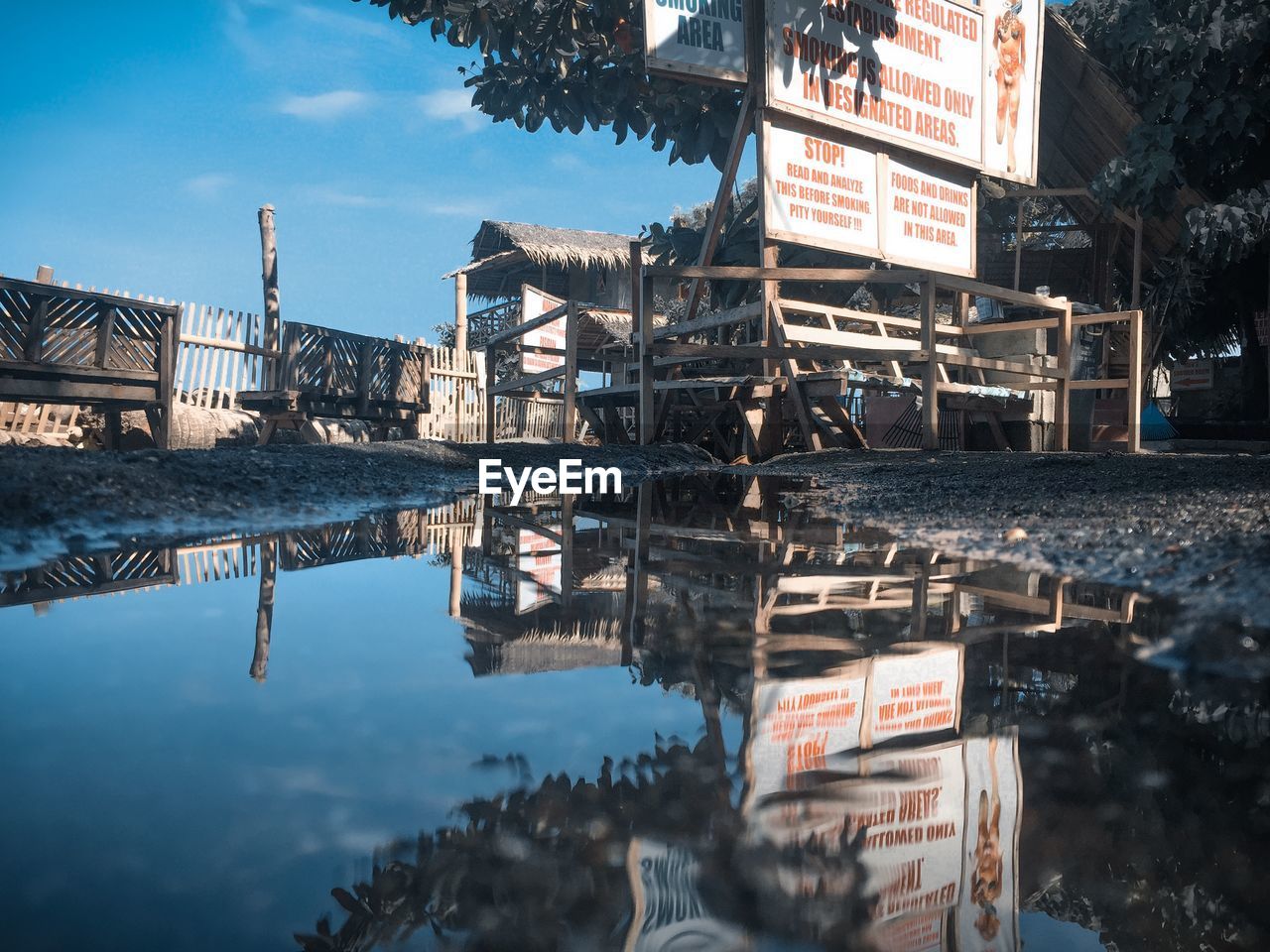 REFLECTION OF BUILDING ON LAKE AGAINST SKY