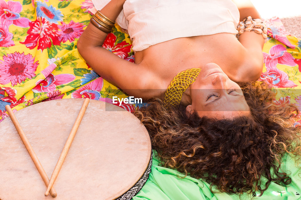 High angle view of woman lying on blanket