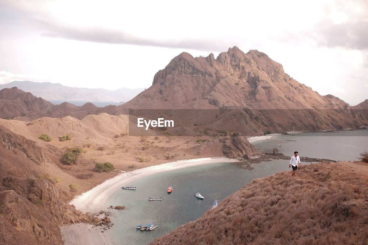 PANORAMIC VIEW OF PEOPLE ON LAND AGAINST SKY