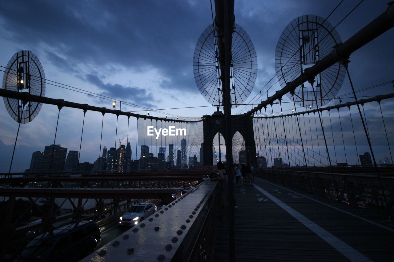 View of suspension bridge against cloudy sky