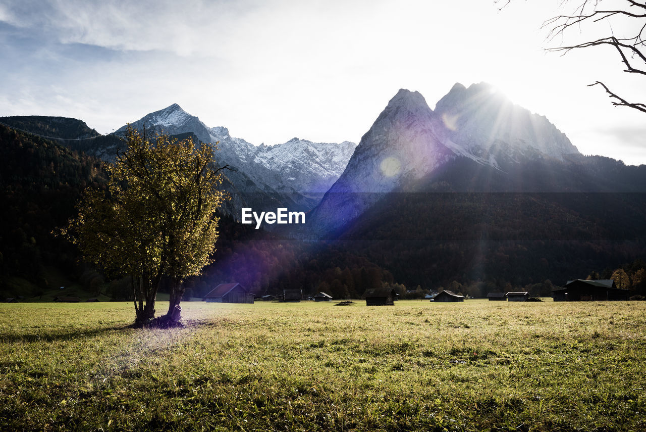 Scenic view of field and mountains against sky