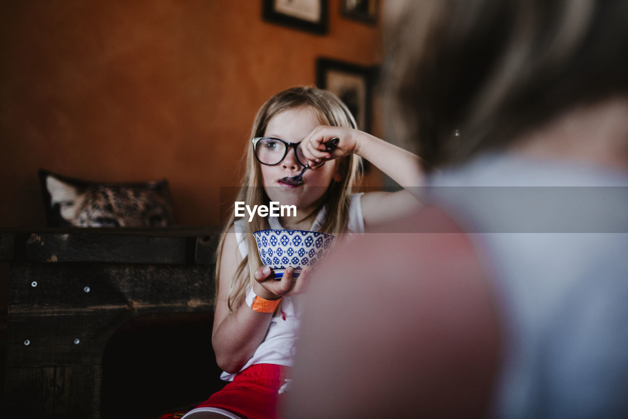 Girl holding bowl and eating