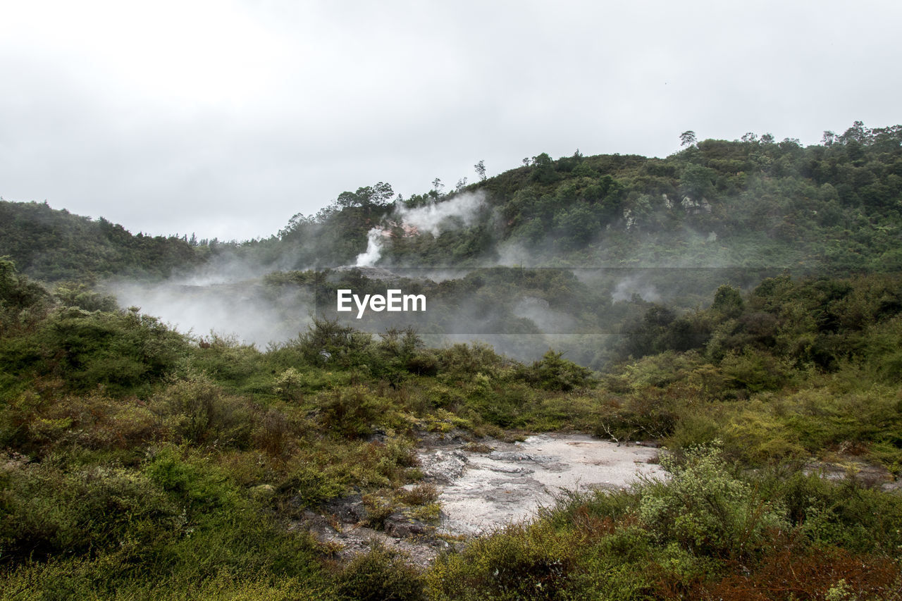 Scenic view of hot springs against sky