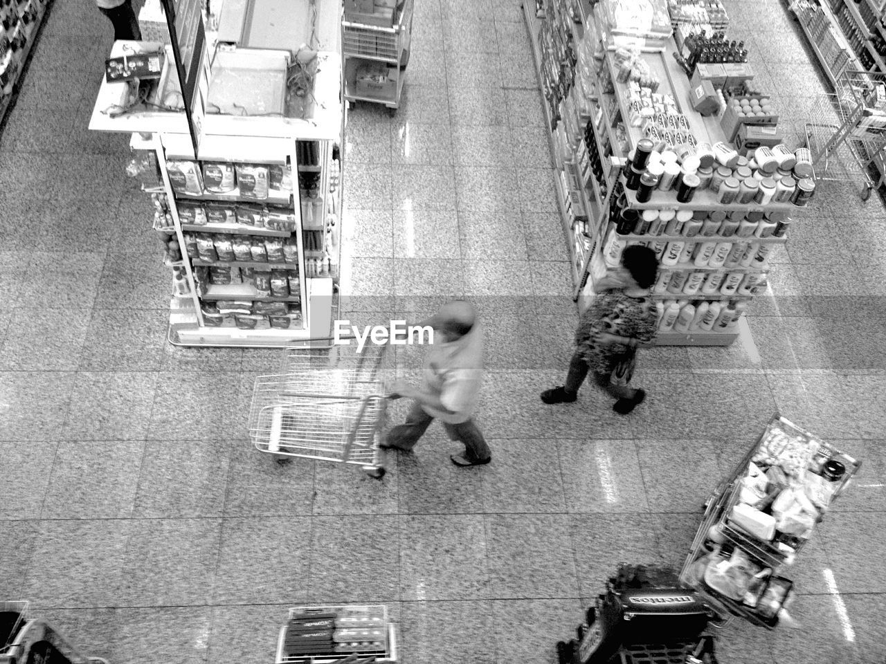 HIGH ANGLE VIEW OF MAN WALKING ON STREET