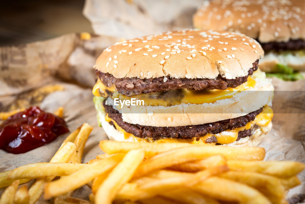 Close-up of hamburger and french fries on paper