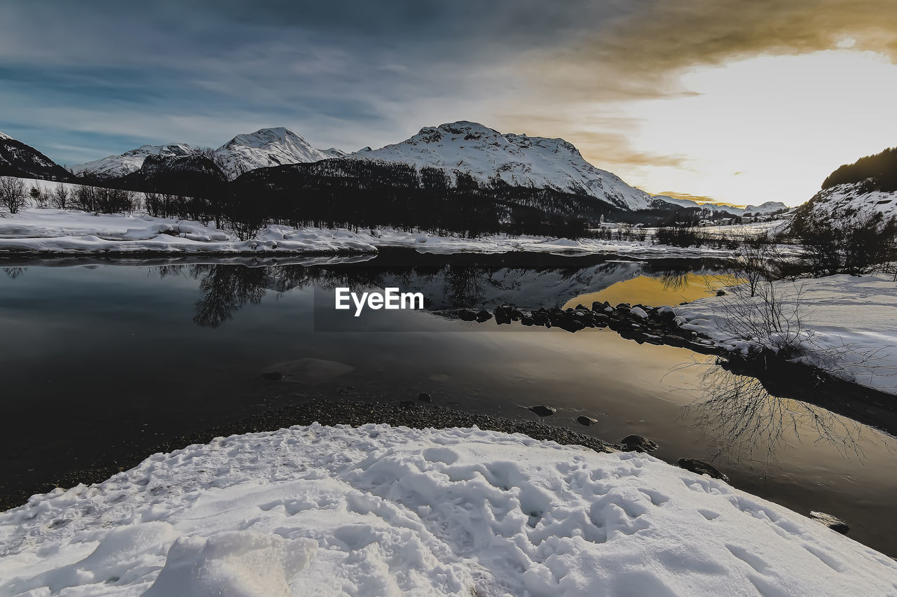 Scenic view of snowcapped mountains against sky during winter