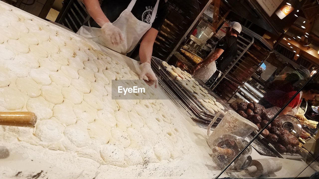 HIGH ANGLE VIEW OF MAN PREPARING FOOD