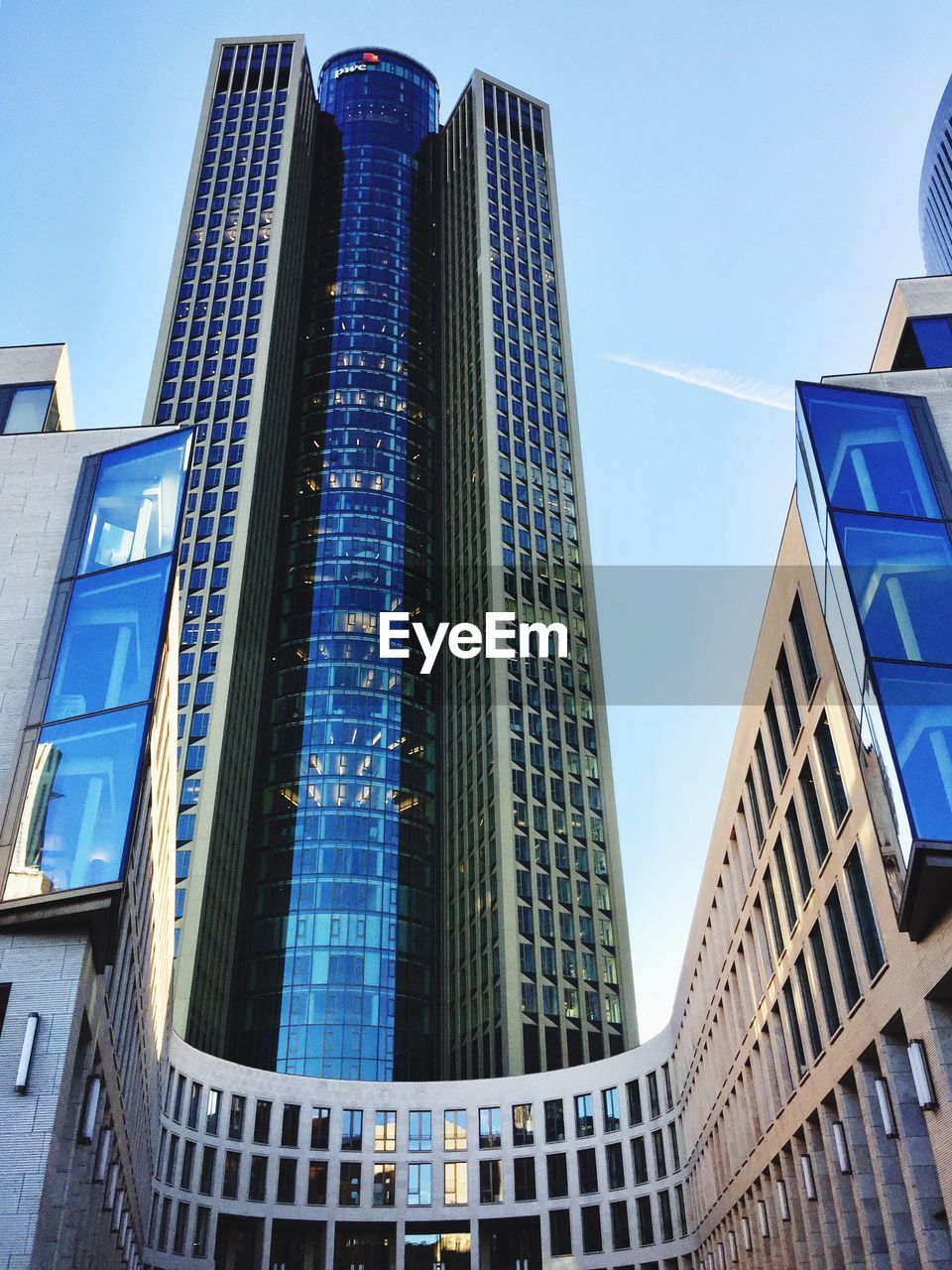 LOW ANGLE VIEW OF OFFICE BUILDINGS AGAINST BLUE SKY