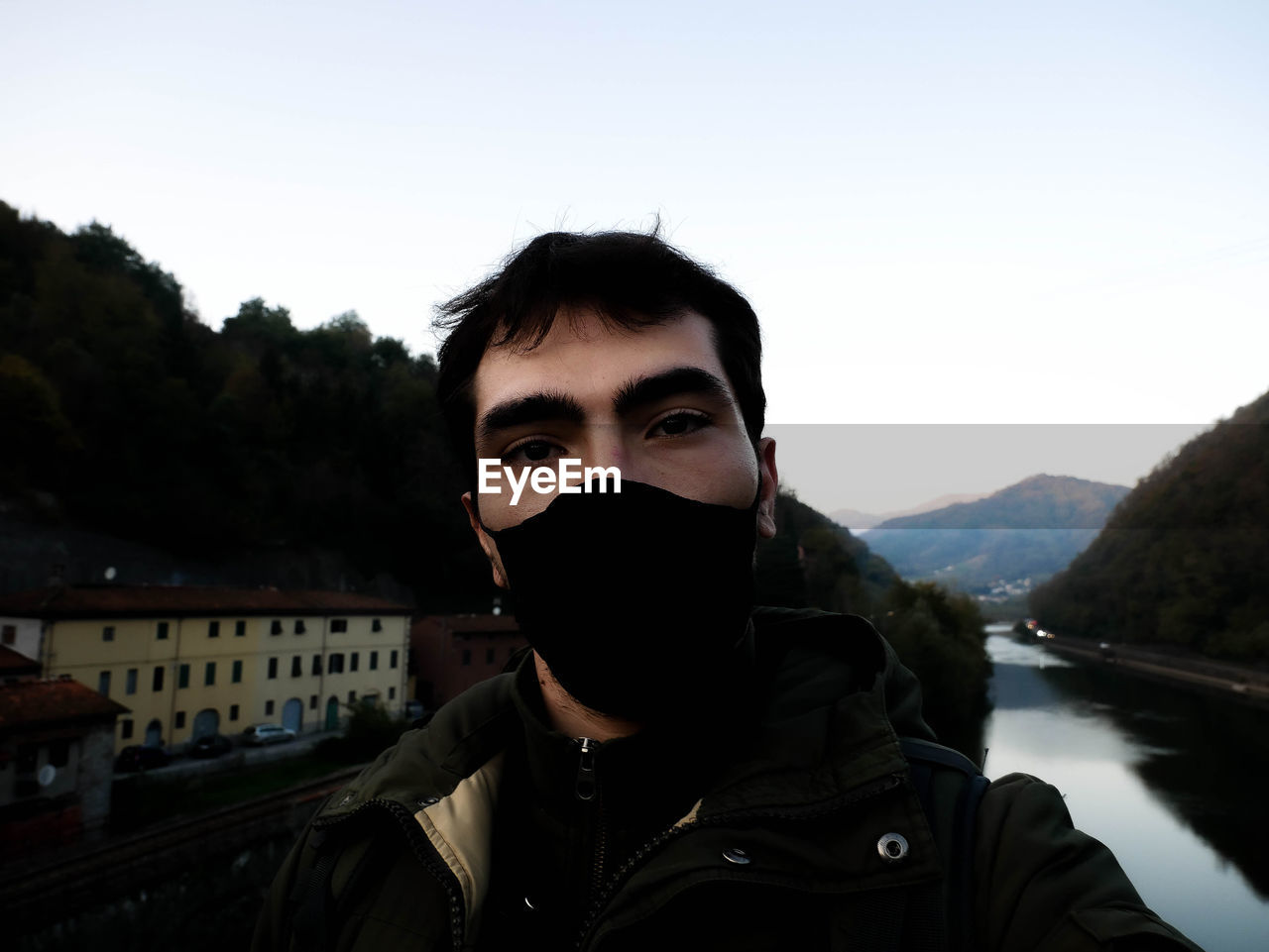 Portrait of young man against sky