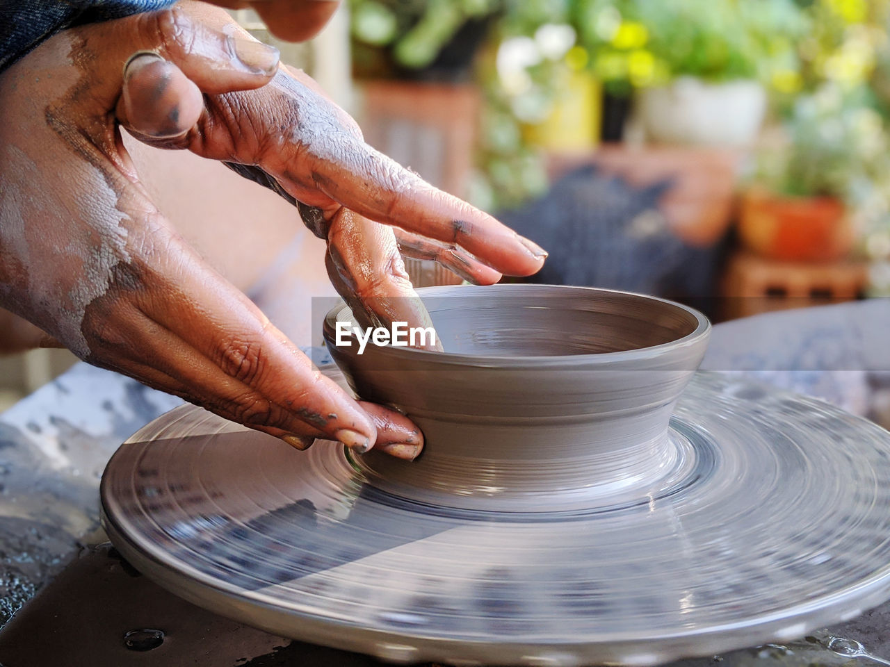 Woman making clay pot ok pottery wheel