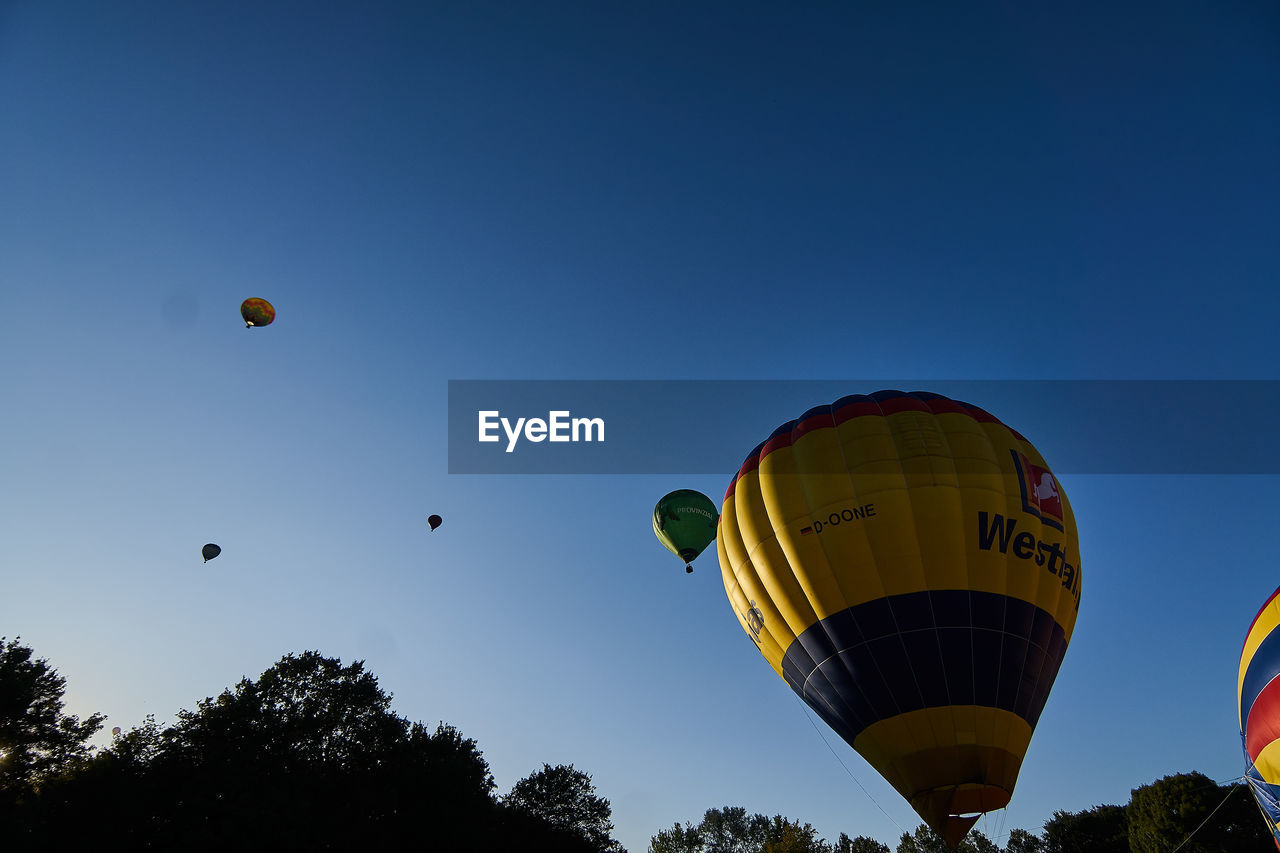 LOW ANGLE VIEW OF HOT AIR BALLOONS AGAINST SKY