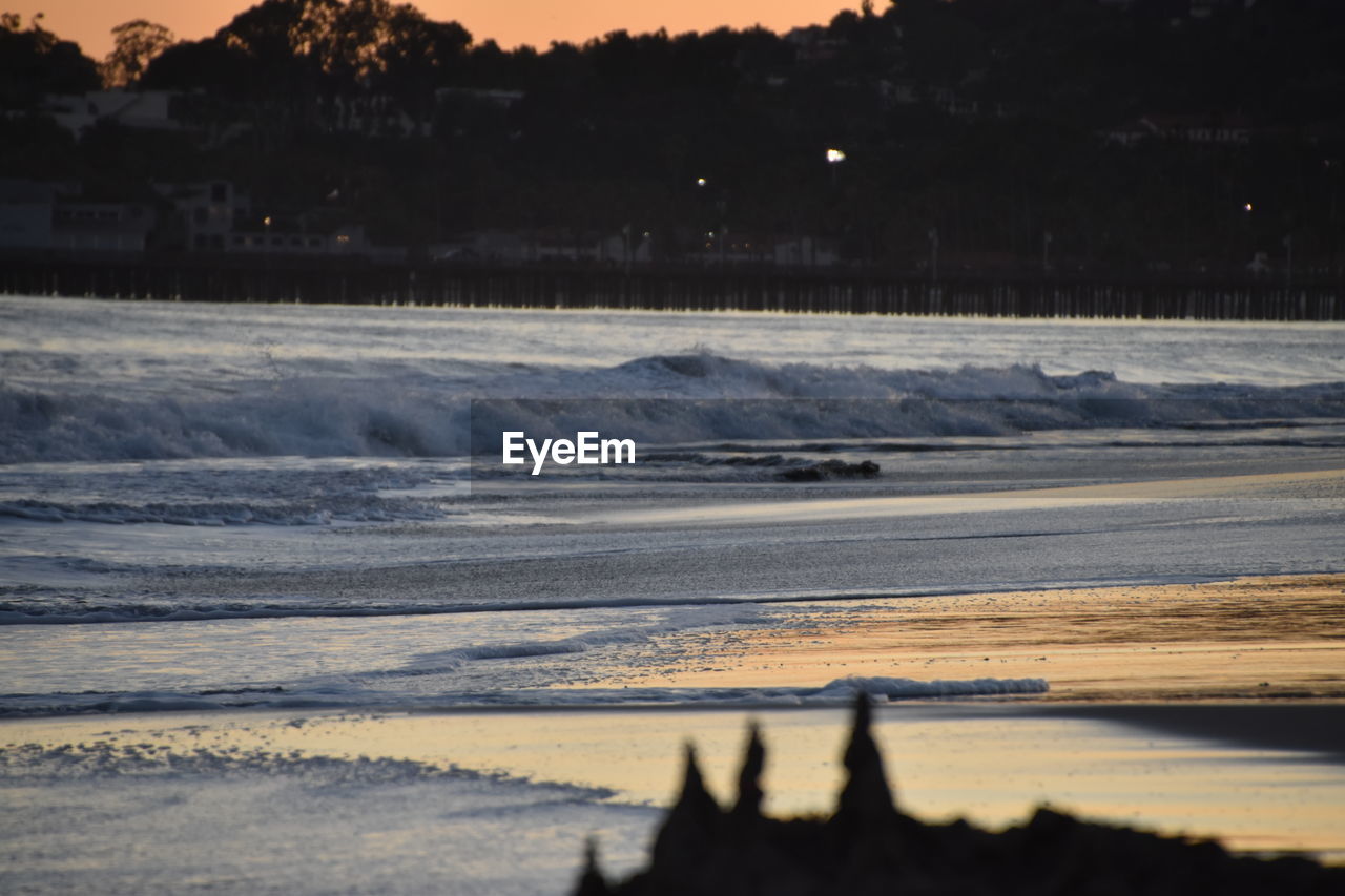 Scenic view of beach against sky during sunset