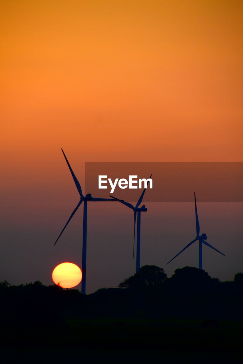 SILHOUETTE OF WIND TURBINES ON LAND