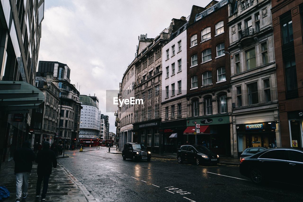 City street amidst buildings during rainy season