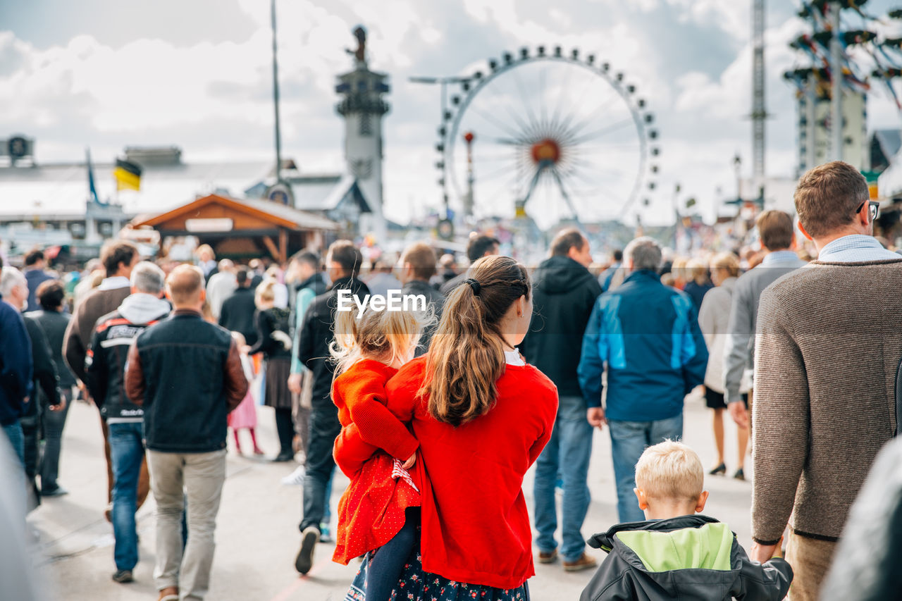 People at amusement park in city