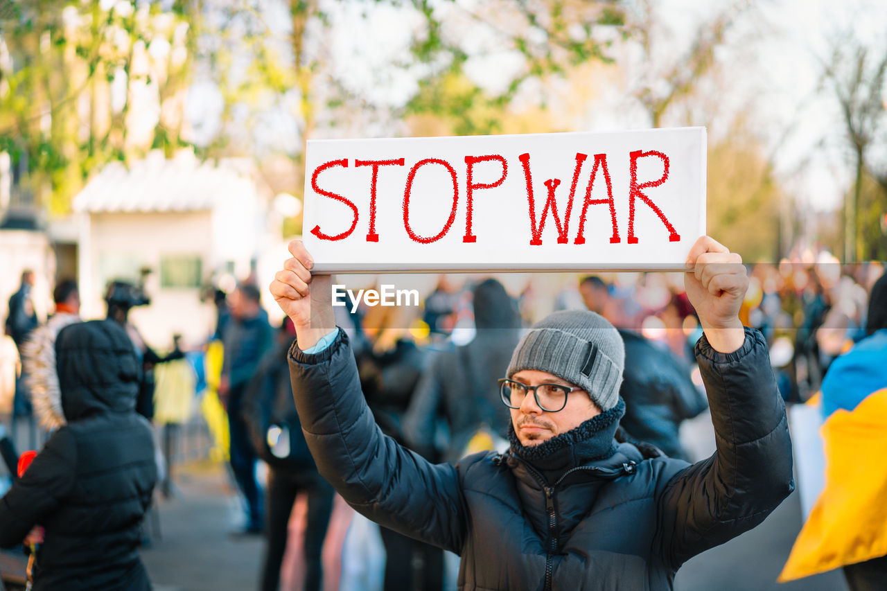 Protestor holding placard at anti-war rally