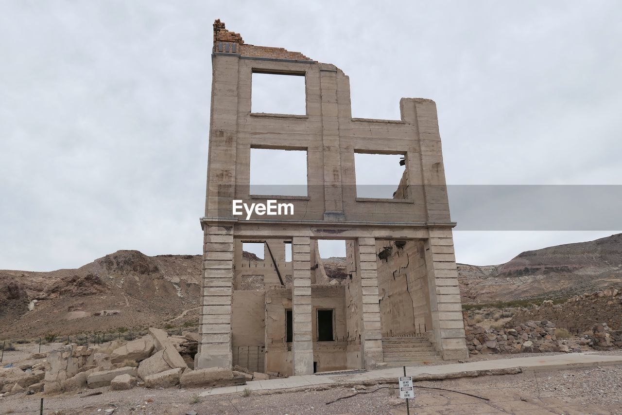 Low angle view of old building against cloudy sky