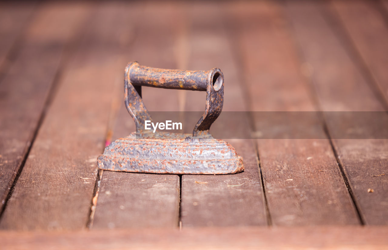 Close-up of rusty iron on table
