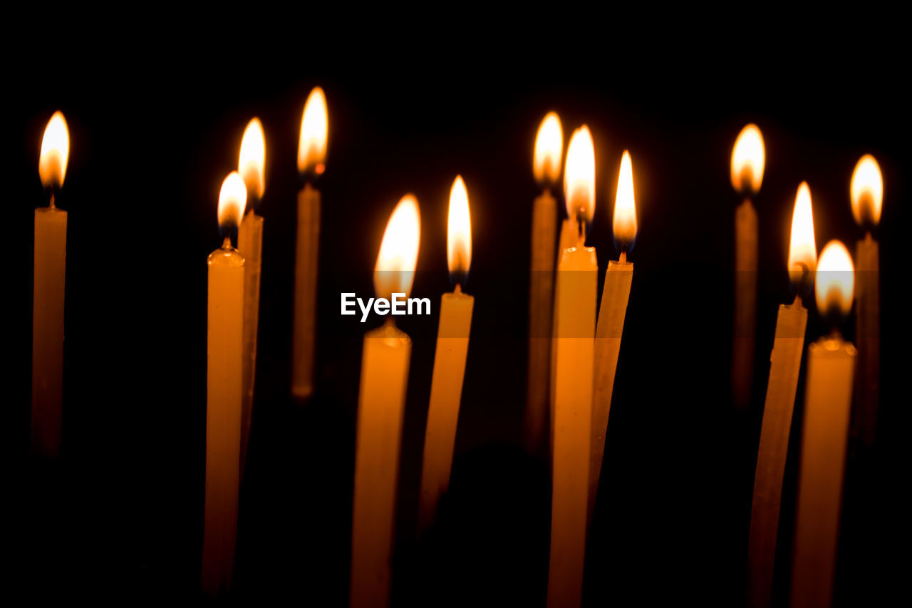 Close-up of lit candles in temple