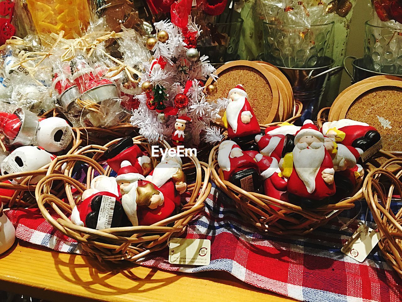 High angle view of christmas figurines in baskets on table