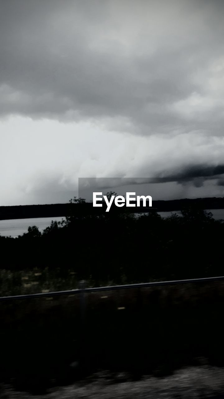SCENIC VIEW OF RIVER AGAINST CLOUDY SKY