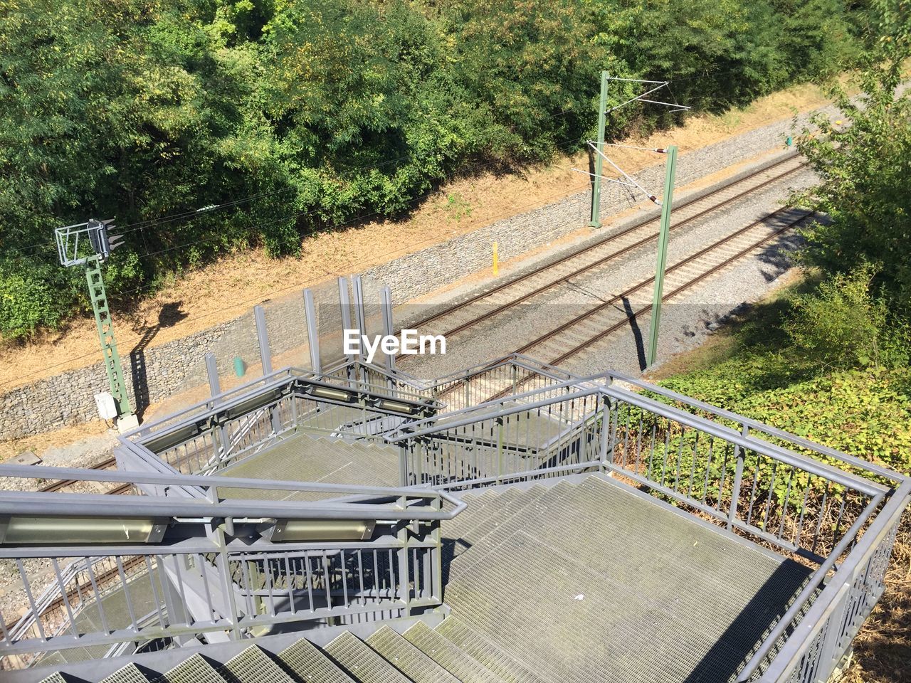 HIGH ANGLE VIEW OF STEPS ON RAILROAD TRACK