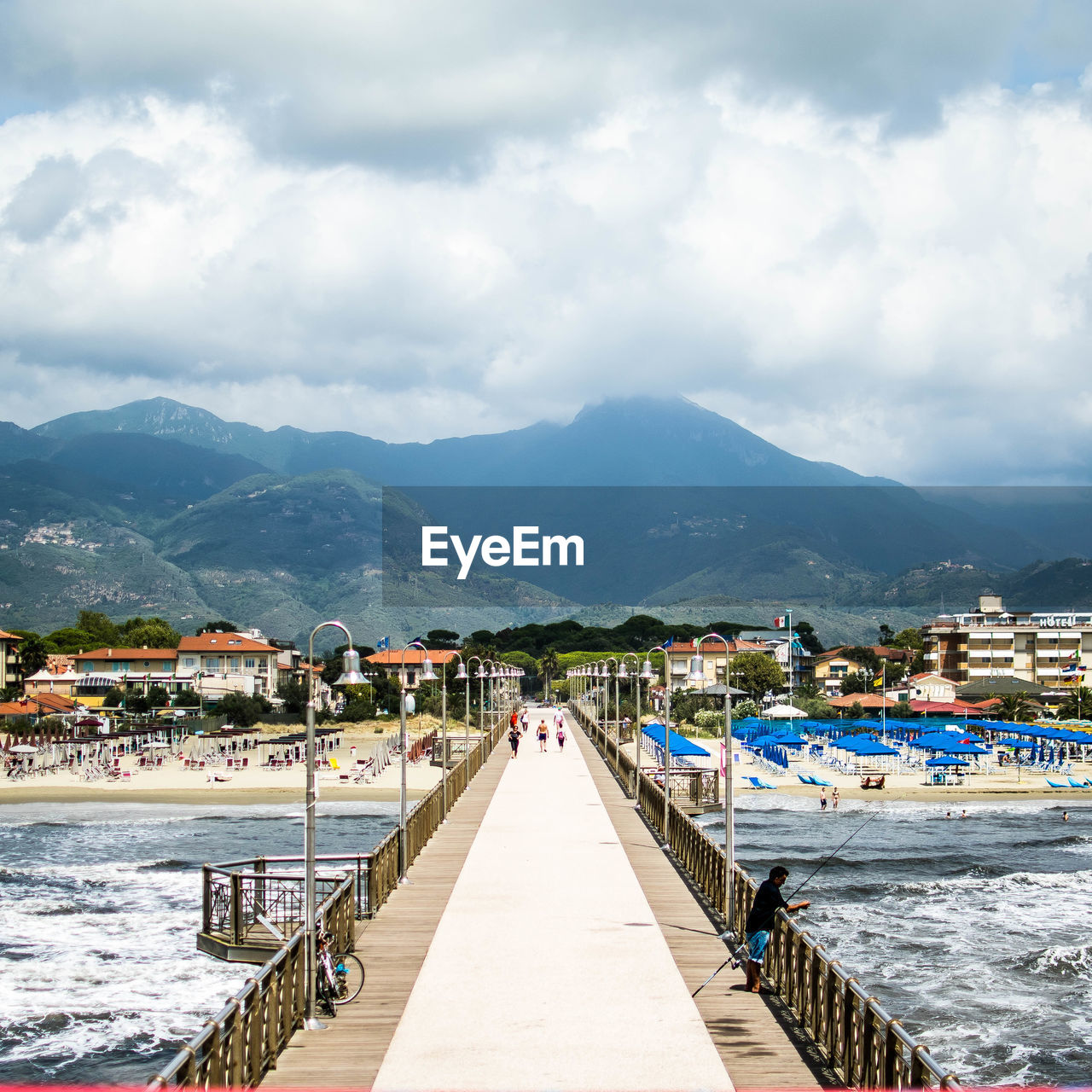 Scenic view of sea and mountains against sky