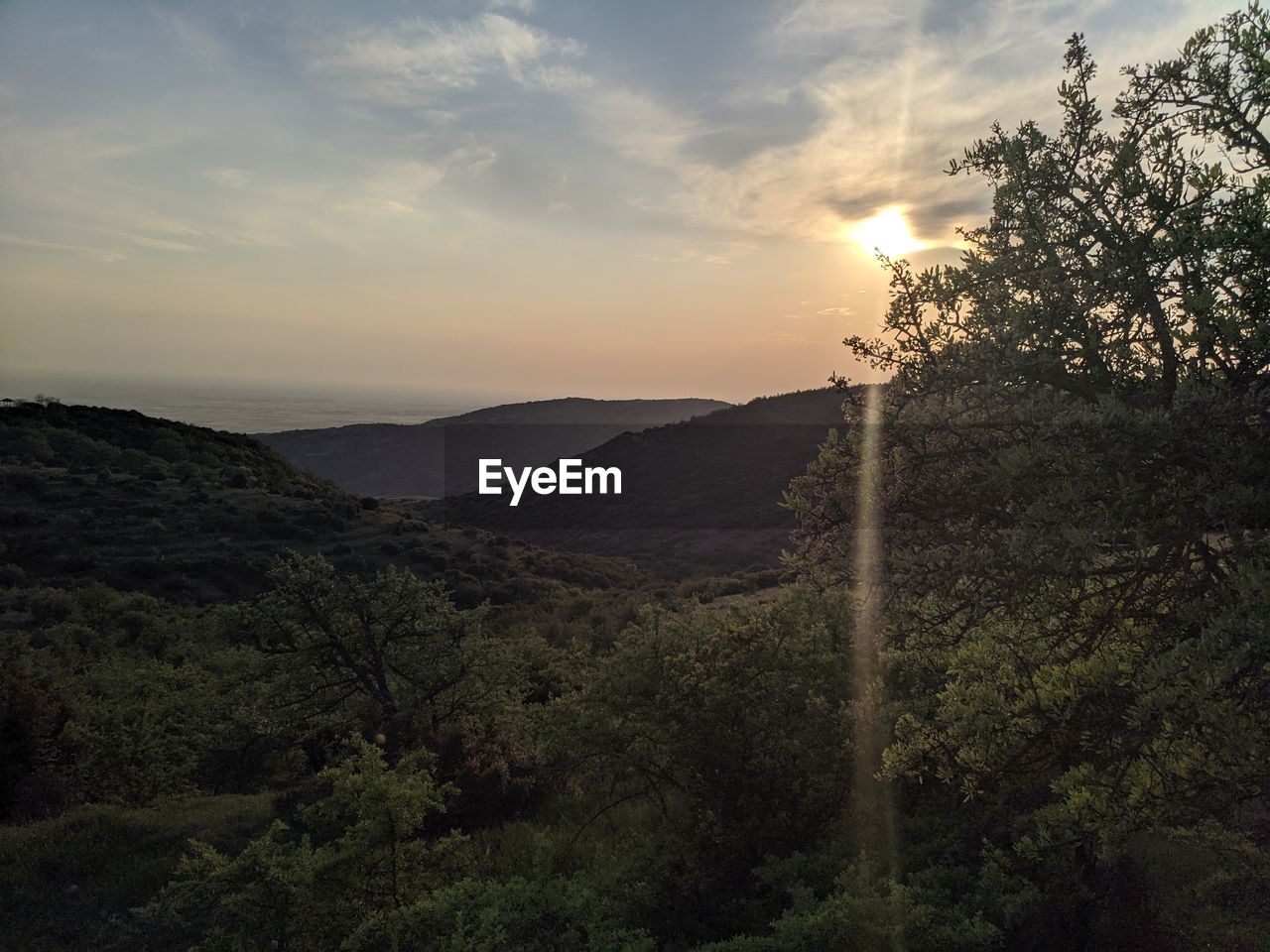 Scenic view of mountains against sky at sunset