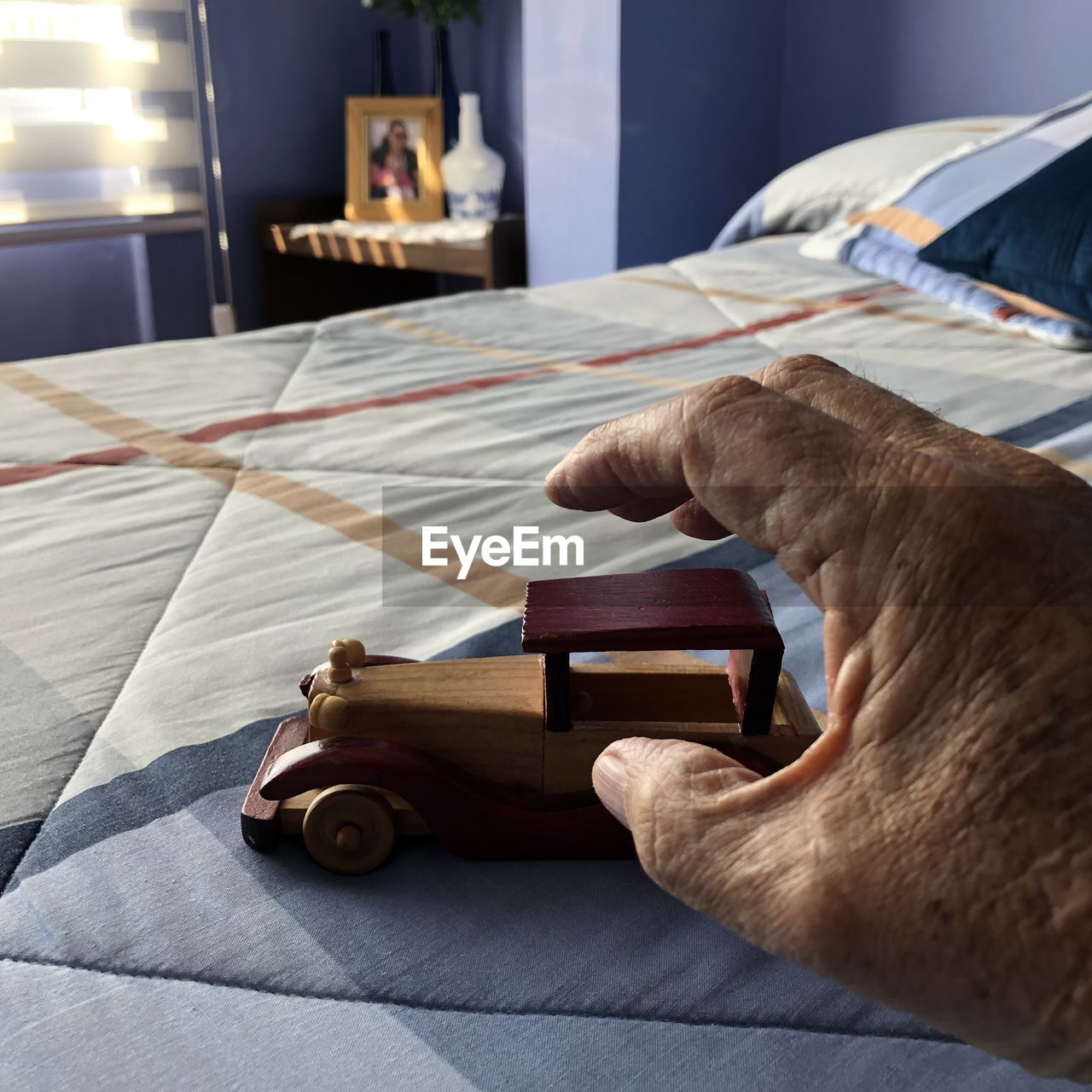 SIDE VIEW OF A DOG ON BED AT HOME