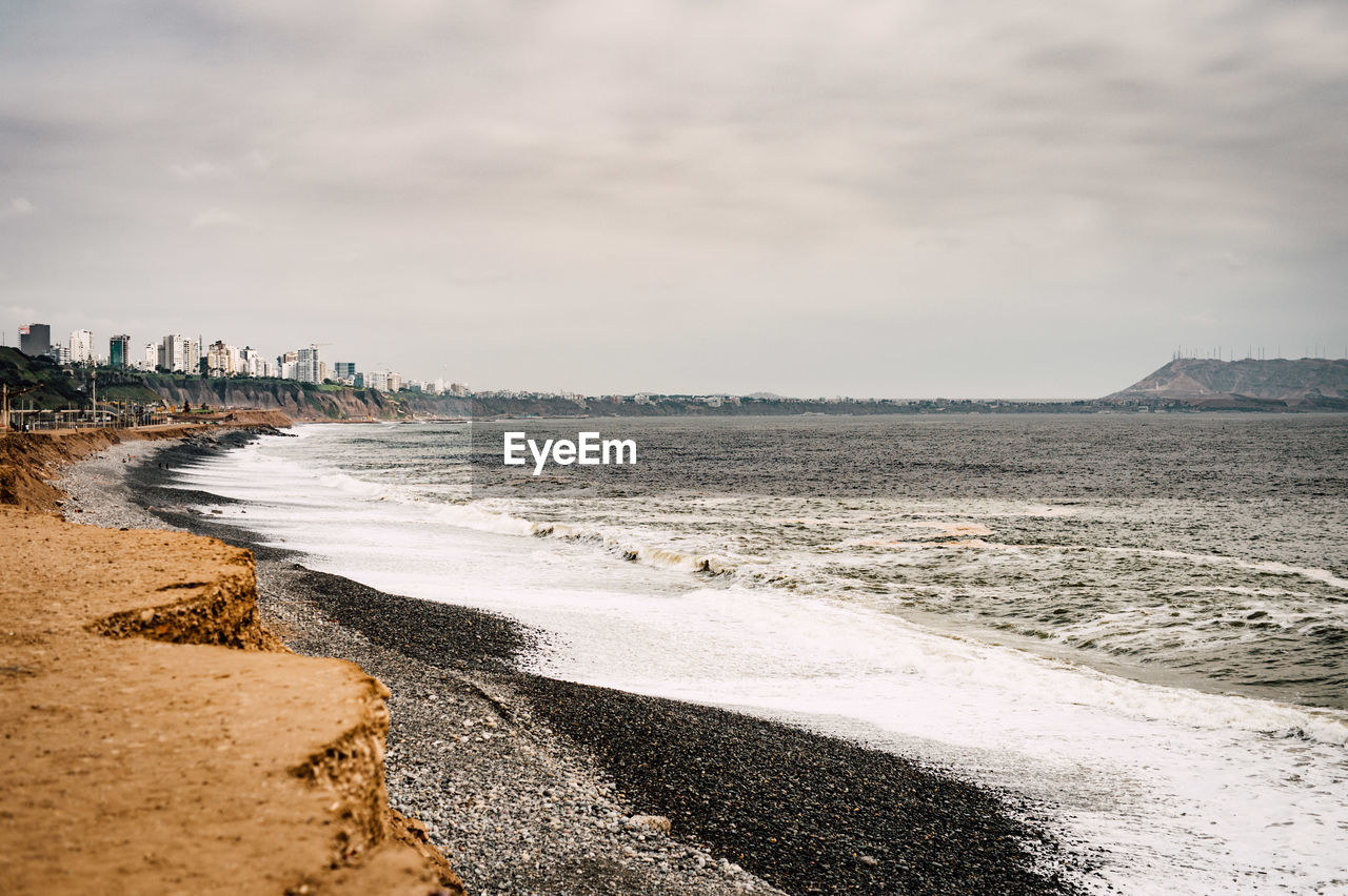 Scenic view of sea against cloudy sky