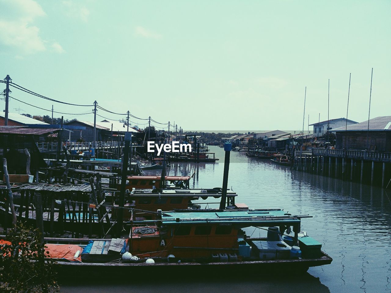 BOATS MOORED IN RIVER