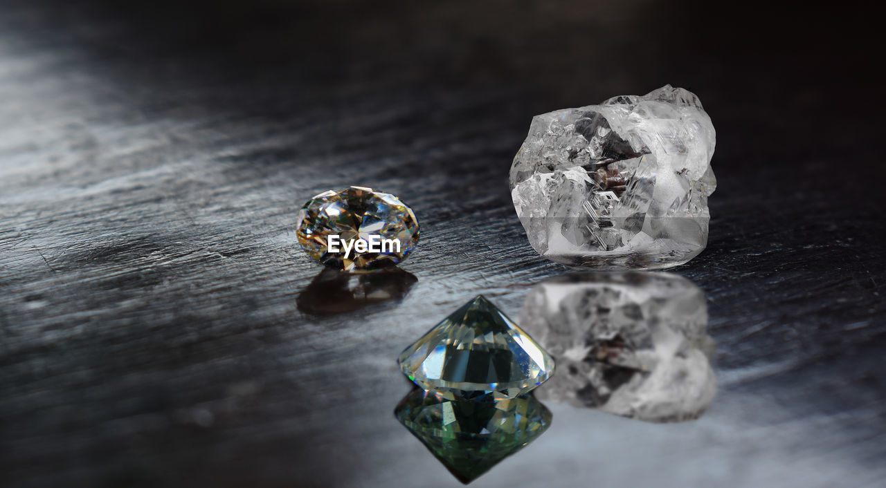 jewellery, fashion accessory, jewelry, wealth, diamond, indoors, gemstone, luxury, no people, studio shot, close-up, still life, precious gem, shiny, table, crystal, macro photography, ring, wood