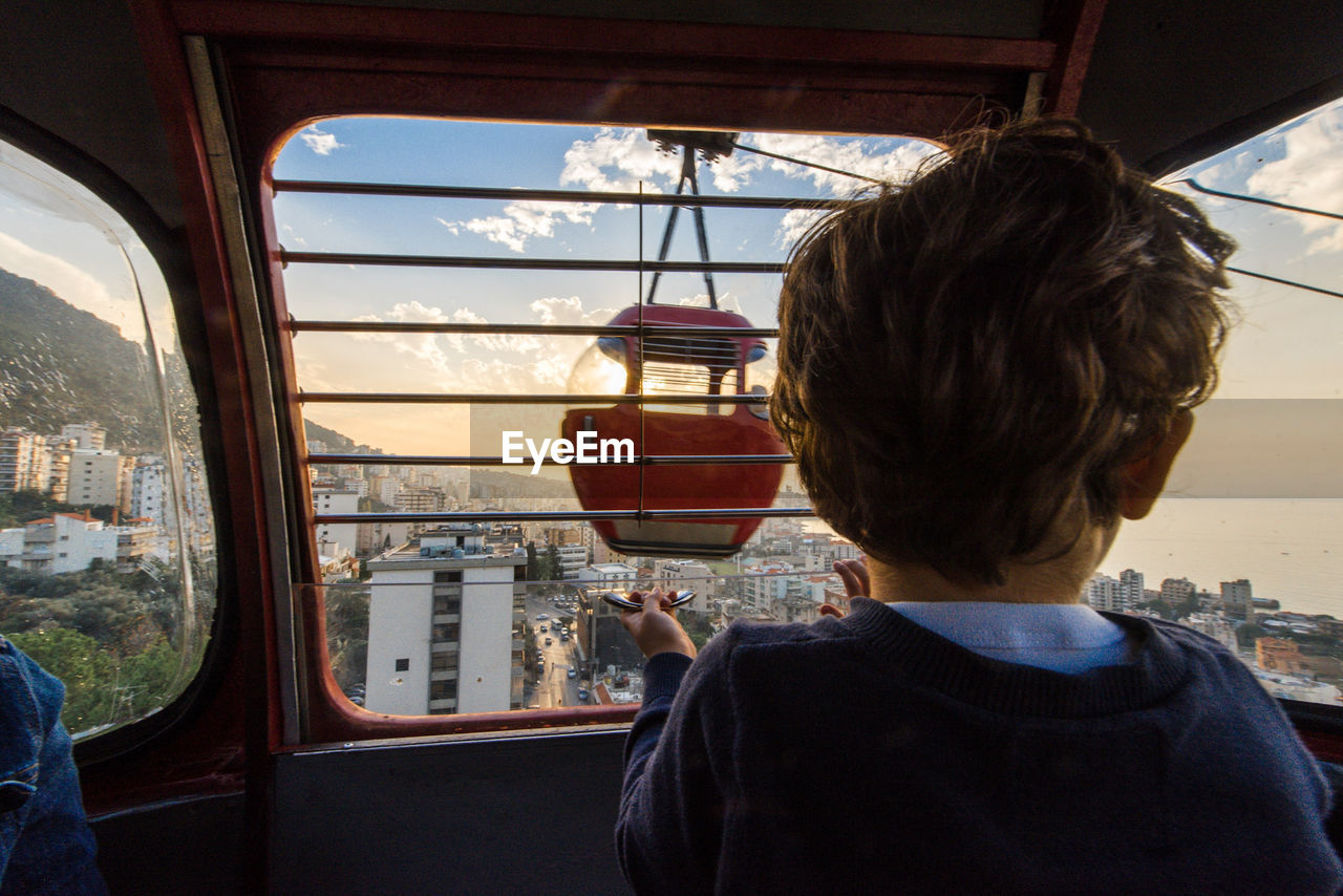 Rear view of boy in overhead cable car