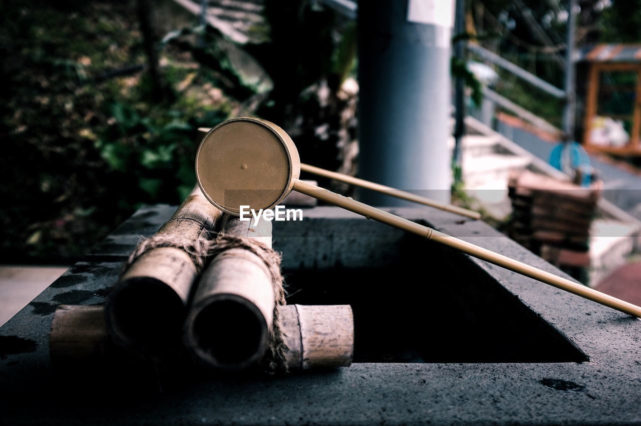 Close-up of wooden ladle on drinking water