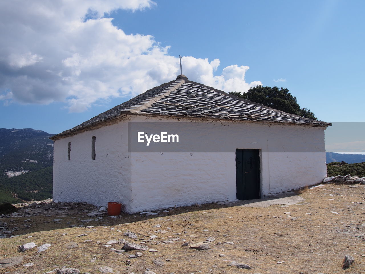 BUILT STRUCTURES ON LANDSCAPE AGAINST SKY