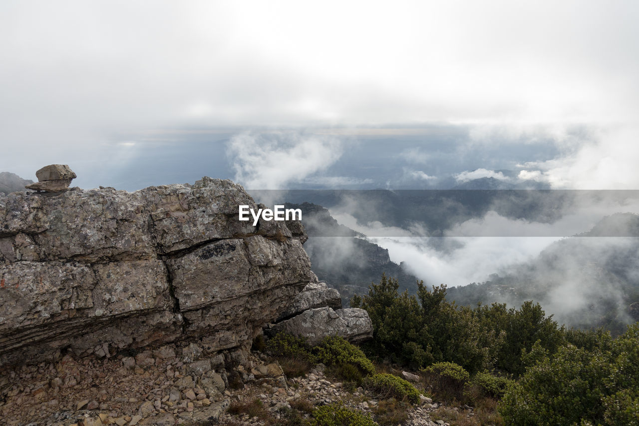 SCENIC VIEW OF CLOUDS OVER MOUNTAIN